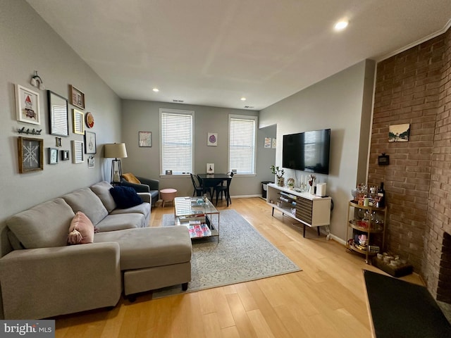 living area featuring recessed lighting, light wood-type flooring, and baseboards