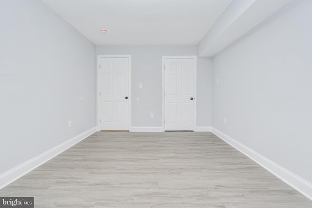 unfurnished bedroom featuring baseboards and light wood-style flooring