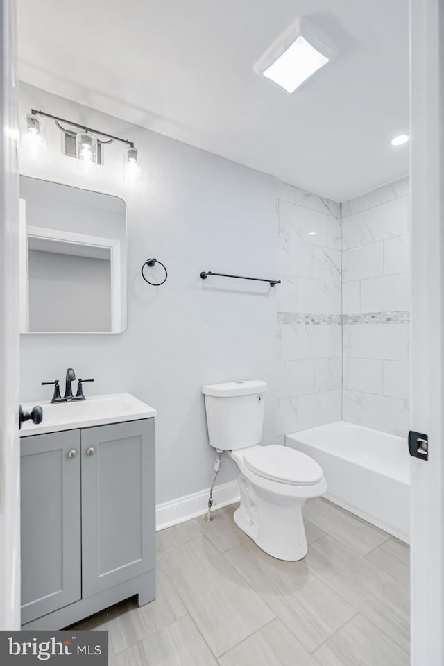 full bath with vanity, baseboards, and toilet