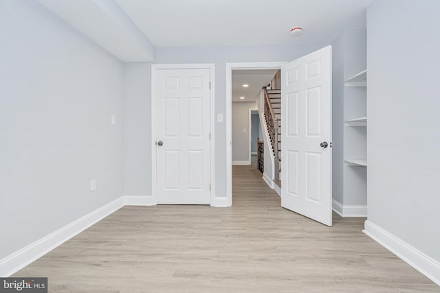 unfurnished bedroom featuring baseboards, recessed lighting, and light wood-style floors