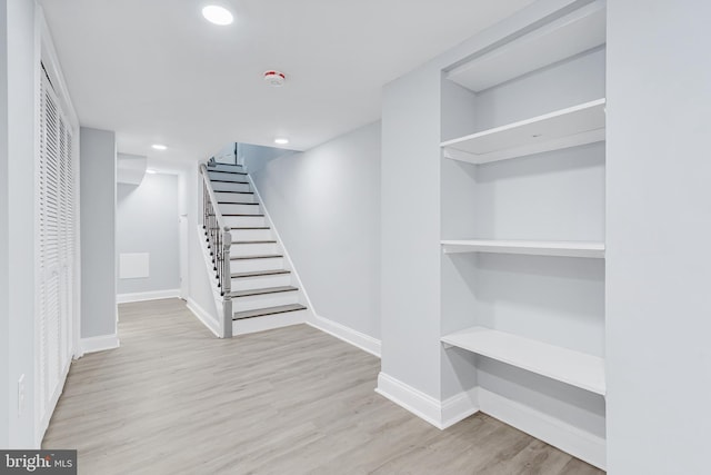interior space featuring baseboards, recessed lighting, and wood finished floors