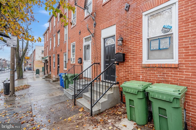 property entrance featuring brick siding