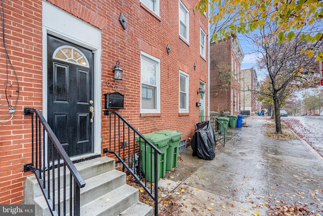 entrance to property featuring brick siding