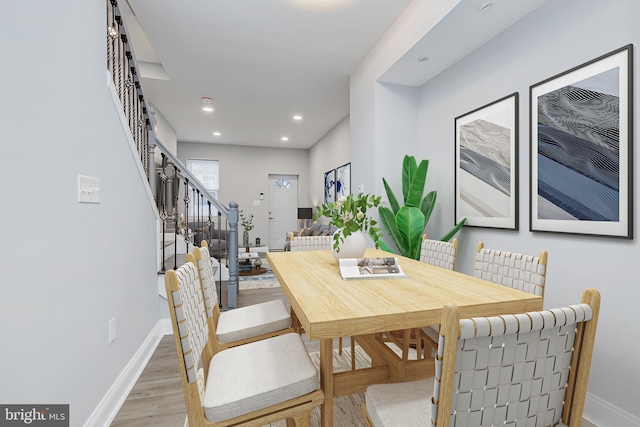 dining room with recessed lighting, baseboards, stairs, and wood finished floors