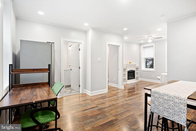 dining area with hardwood / wood-style flooring, crown molding, and ceiling fan