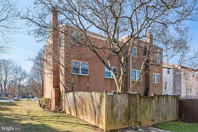 view of side of property with a lawn