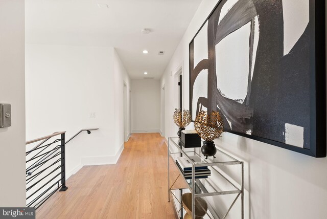 corridor with light hardwood / wood-style floors