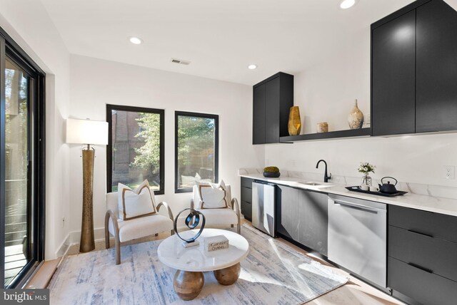 kitchen with sink, dishwasher, and refrigerator