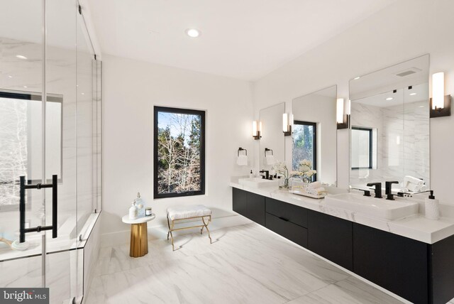 bathroom with a shower with door and vanity