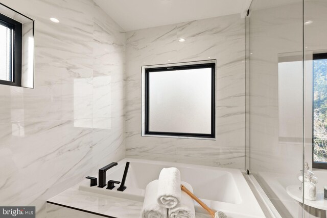 bathroom with tiled tub