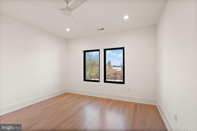 unfurnished room with ceiling fan and light wood-type flooring