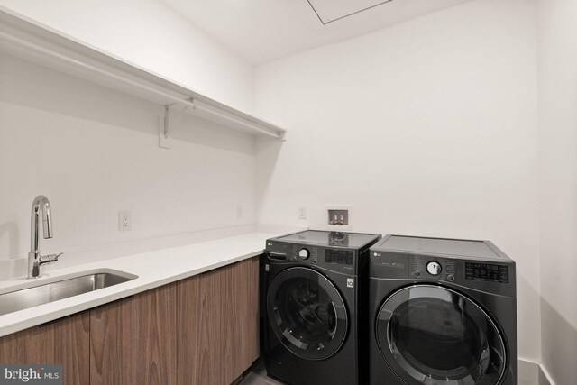 laundry area featuring sink and washer and dryer