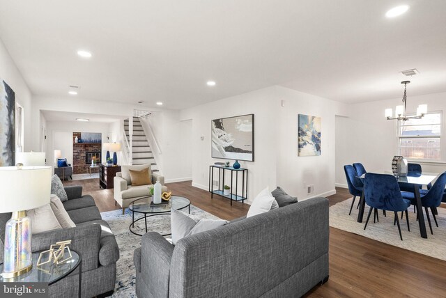 living room featuring dark wood-type flooring and a notable chandelier