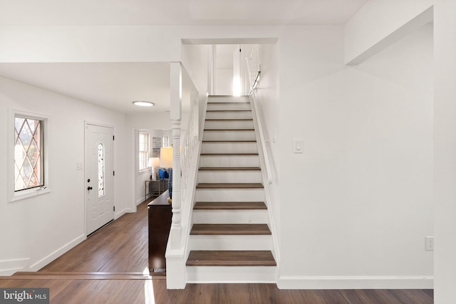 stairs featuring hardwood / wood-style floors