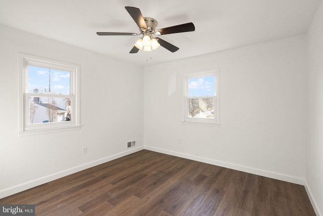 empty room featuring ceiling fan and dark hardwood / wood-style floors