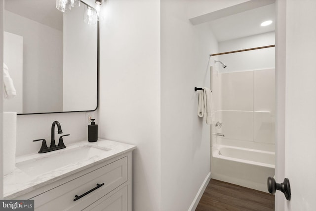 bathroom featuring shower / tub combination, vanity, and hardwood / wood-style floors