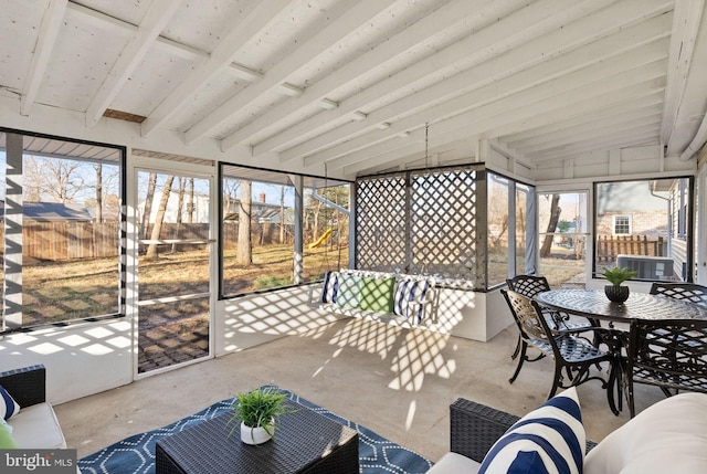 sunroom / solarium with lofted ceiling with beams