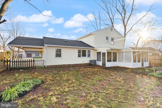 rear view of property featuring central AC and a sunroom