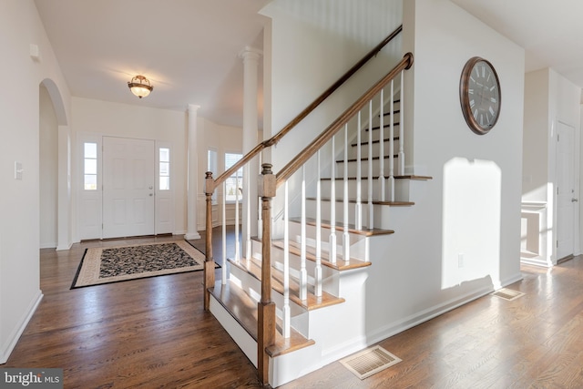 entrance foyer with dark wood-type flooring and ornate columns