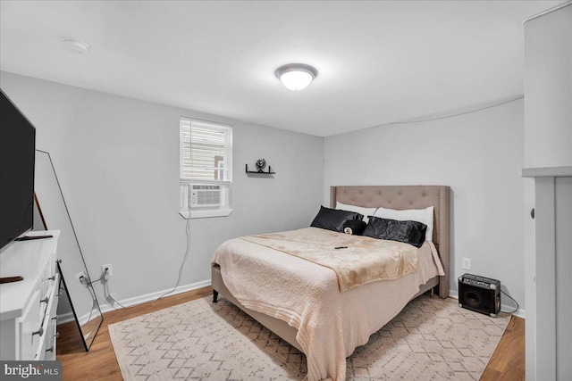 bedroom featuring cooling unit and light hardwood / wood-style flooring