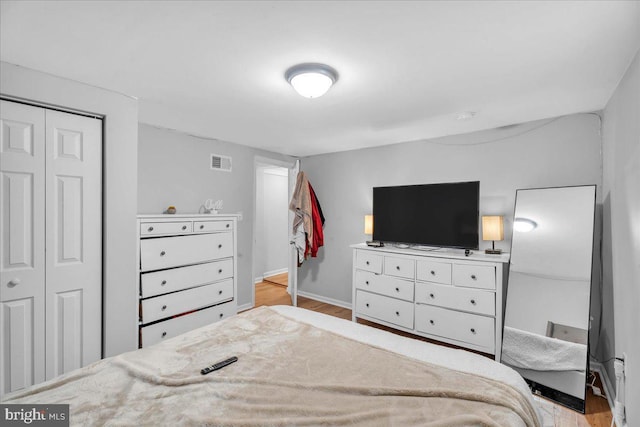 bedroom featuring light hardwood / wood-style flooring and a closet