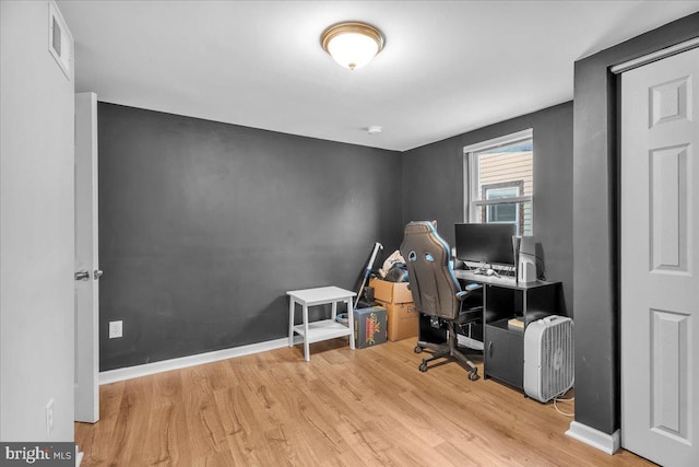 office with light wood-type flooring