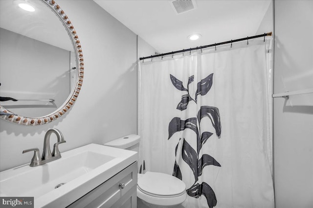 bathroom with vanity, toilet, and a shower with shower curtain