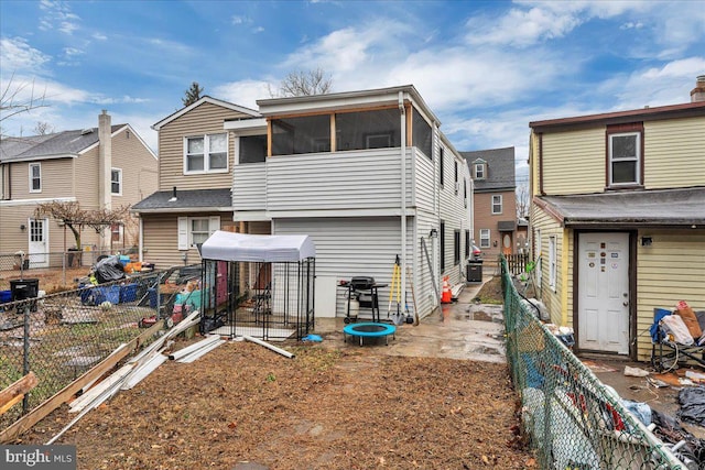 back of house featuring a sunroom