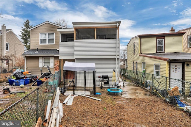 back of house featuring a sunroom