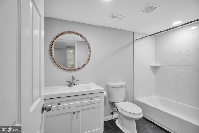 full bathroom with tile patterned floors, vanity, toilet, and tiled shower / bath combo