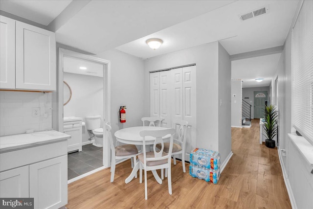 dining space with light hardwood / wood-style floors