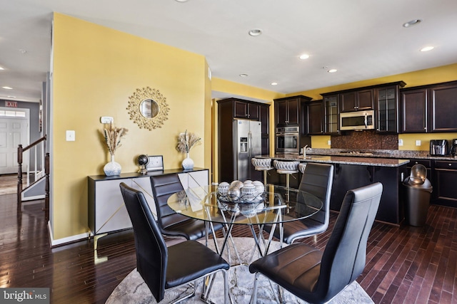 dining area featuring sink and dark hardwood / wood-style floors