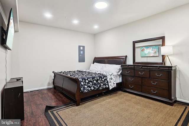 bedroom with dark hardwood / wood-style floors