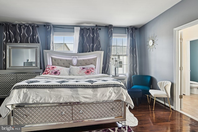 bedroom featuring multiple windows and dark wood-type flooring