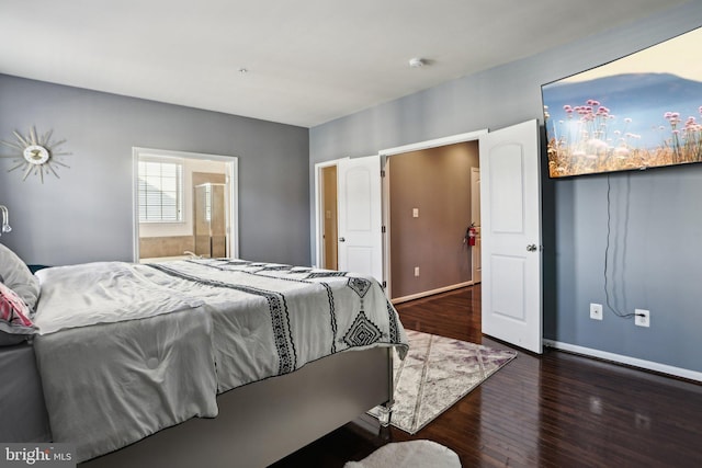 bedroom with dark hardwood / wood-style floors and ensuite bathroom