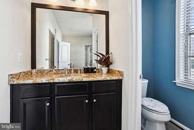 bathroom featuring vanity and toilet