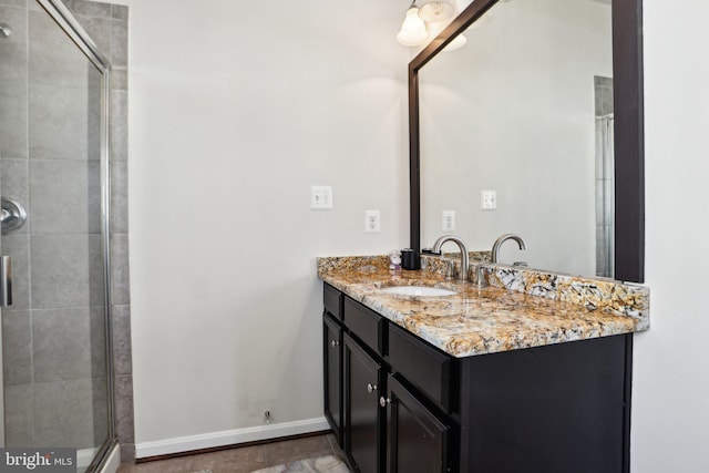 bathroom with vanity and a shower with door