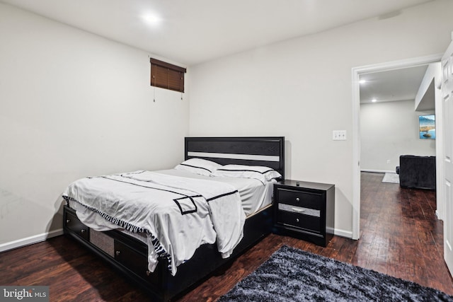 bedroom with dark wood-type flooring