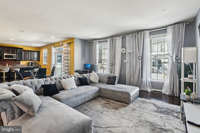 living room featuring plenty of natural light and hardwood / wood-style floors