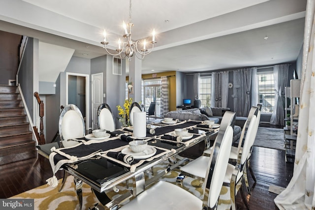 dining area featuring dark hardwood / wood-style floors and a notable chandelier