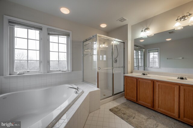 bathroom featuring tile patterned floors, plenty of natural light, independent shower and bath, and vanity