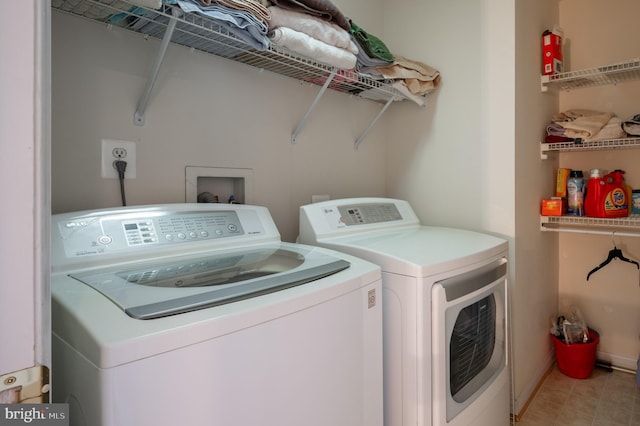 laundry room with tile patterned floors and washing machine and dryer