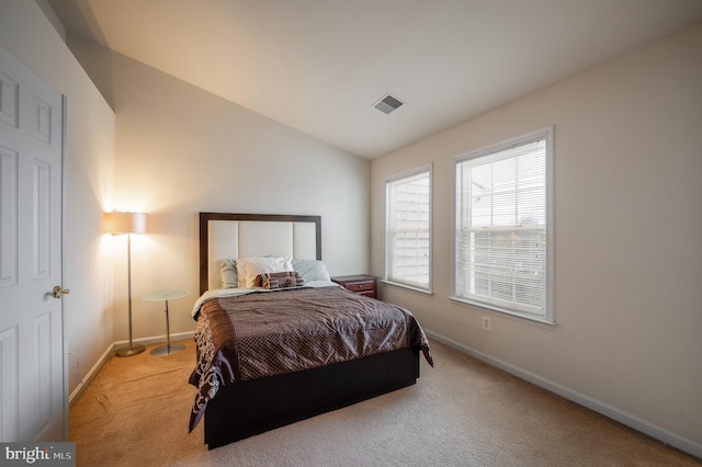 carpeted bedroom featuring lofted ceiling