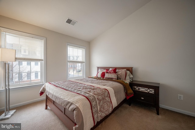 bedroom with vaulted ceiling and carpet floors