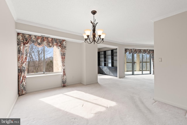 unfurnished dining area with crown molding, plenty of natural light, carpet flooring, and an inviting chandelier