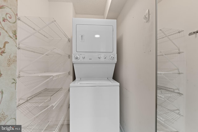 washroom featuring stacked washer and dryer