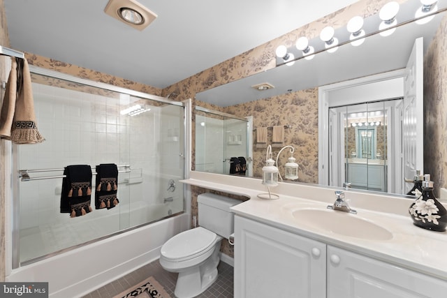 full bathroom with vanity, tile patterned flooring, enclosed tub / shower combo, and toilet