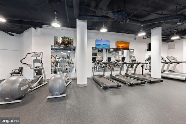 gym featuring ornate columns