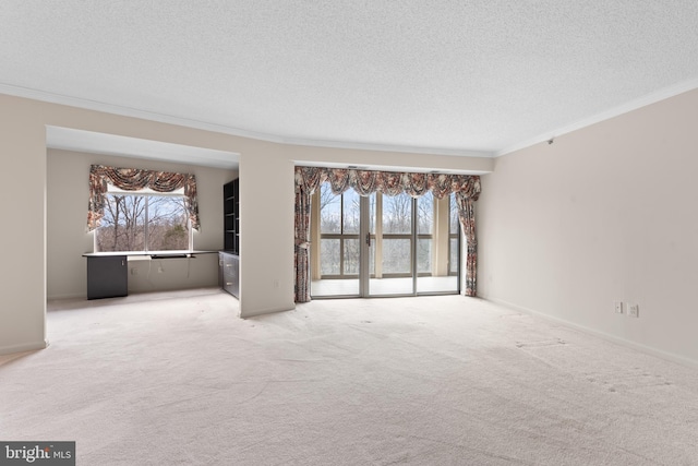 unfurnished living room featuring crown molding, carpet floors, and a textured ceiling