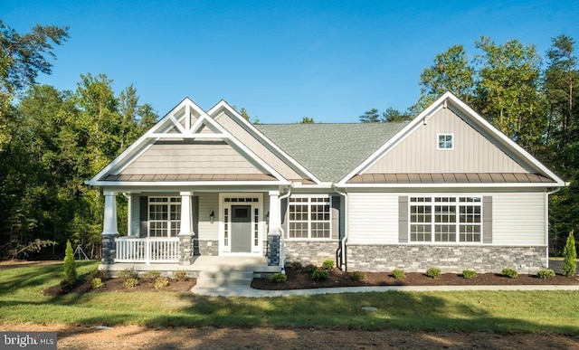 craftsman inspired home with a porch and a front yard